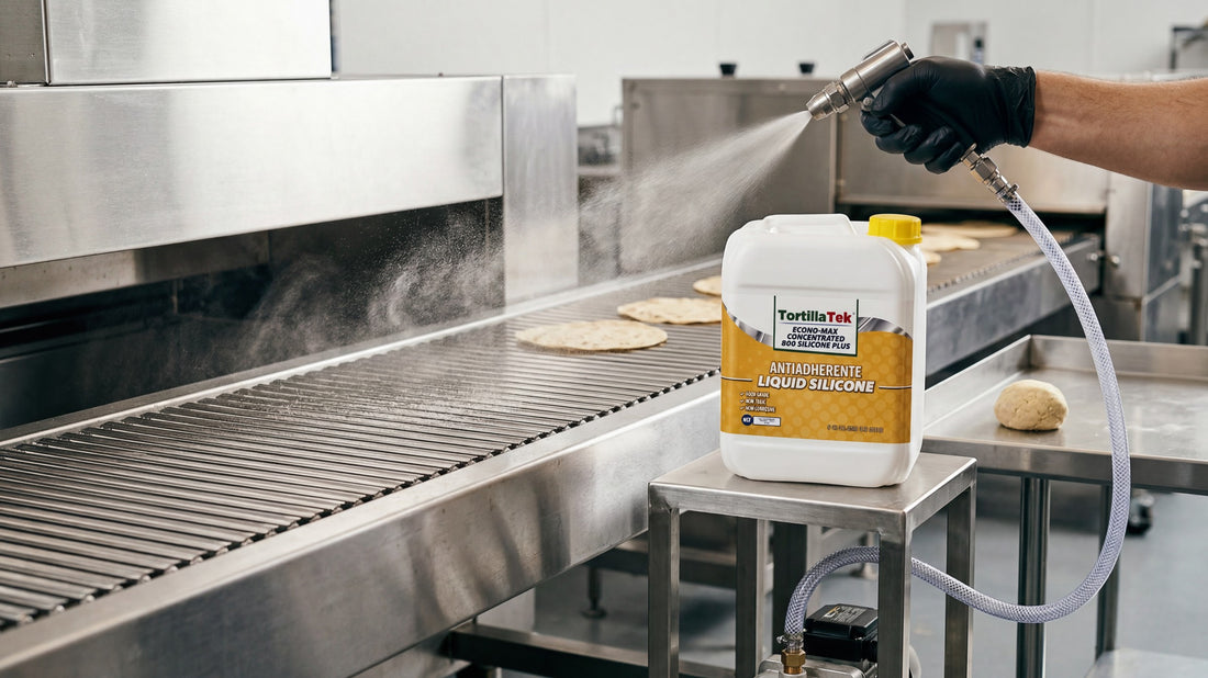 TortillaTek Econo-Max Concentrated 800 Silicone Plus food grade silicone being sprayed onto a tortilla line conveyor with the oven entry behind